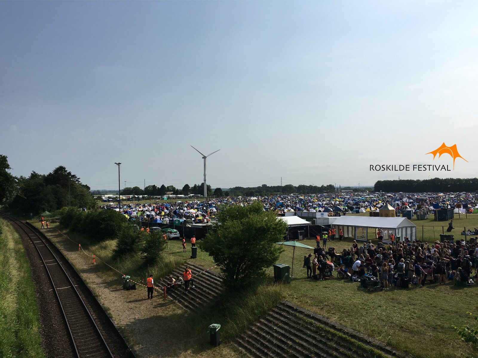 Large crowd flow at a festival site.